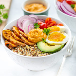 Breakfast bowl with avocado, sweet potato, onion, tomato and quinoa beauty image